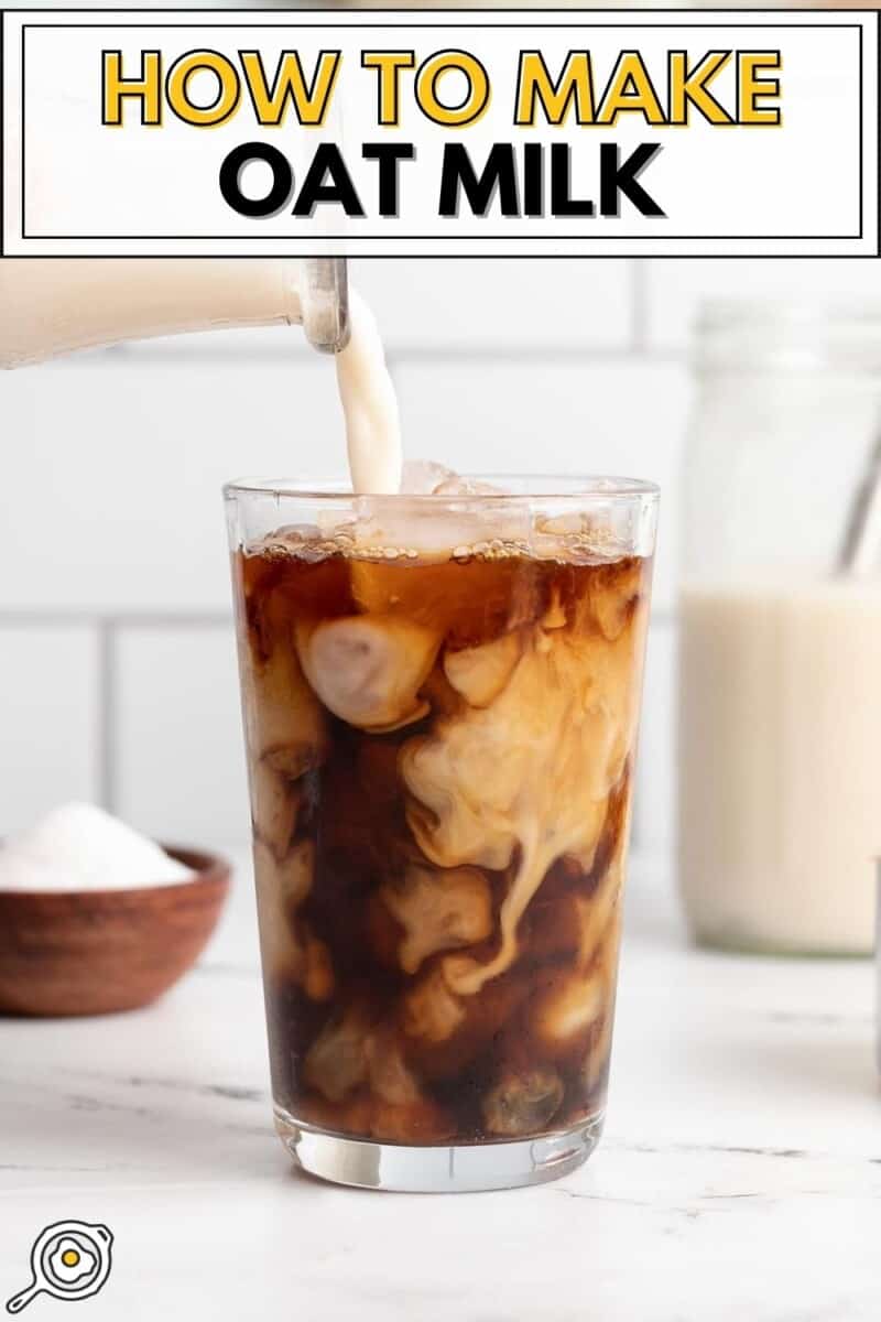 Oat milk being poured into an iced coffee.