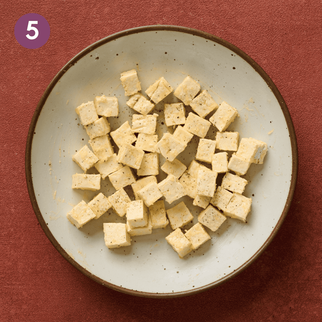 potato starch mixed in with tofu cubes in a bowl.