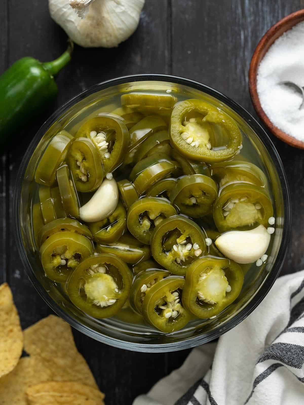 Overhead view of a bowl full of pickled jalapeños.
