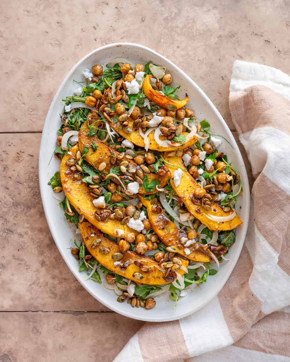 Pumpkin Salad on a large white serving platter on a table.
