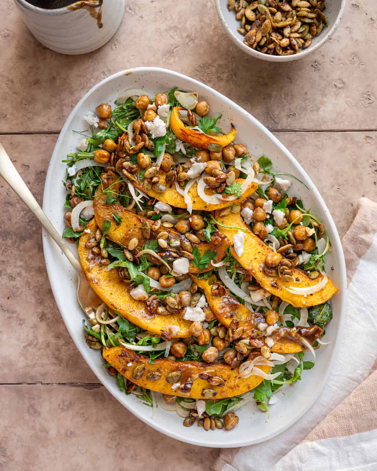Pumpkin Salad on a large white serving platter on a table.
